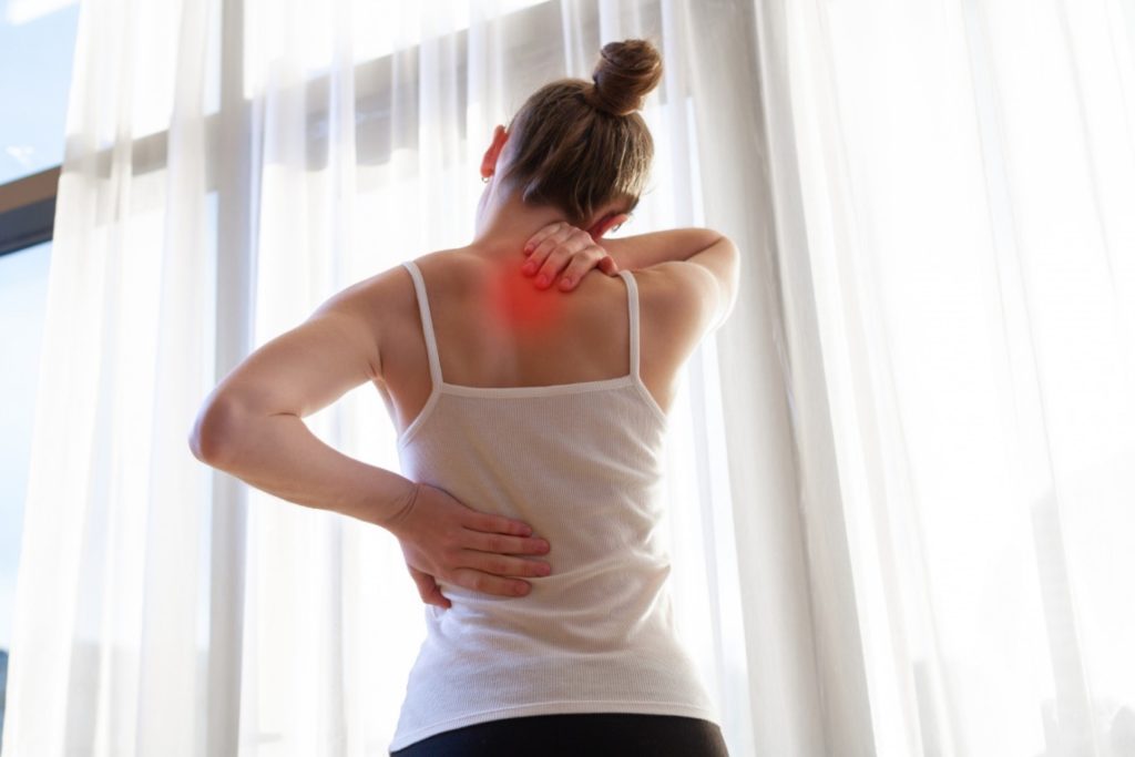 A lady with back pain and pain between shoulder blades