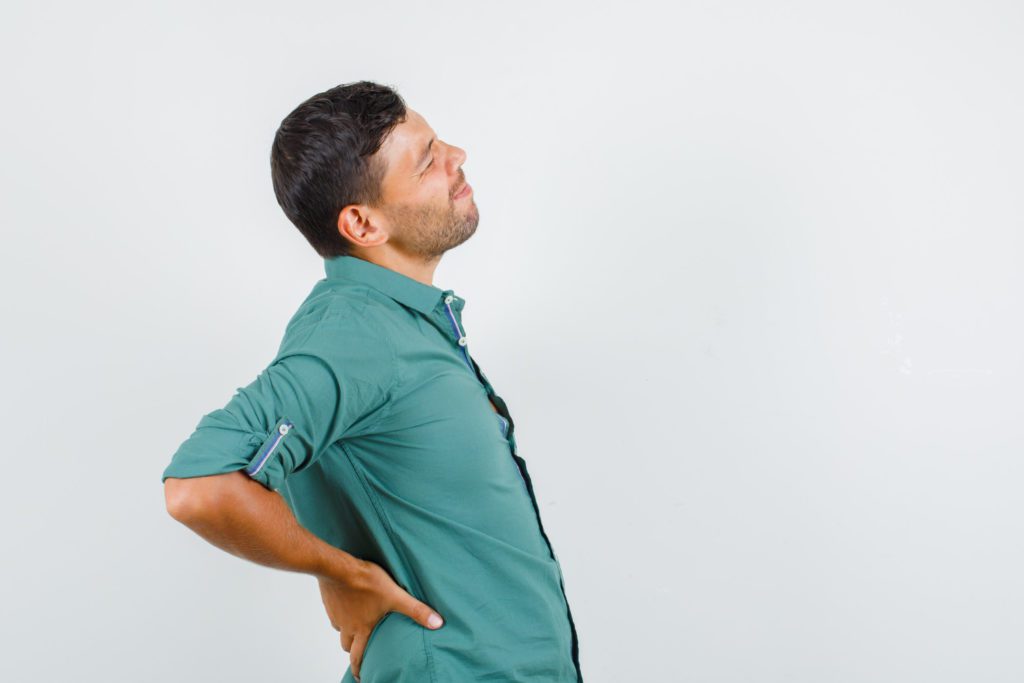 A man holding his back pain red flag