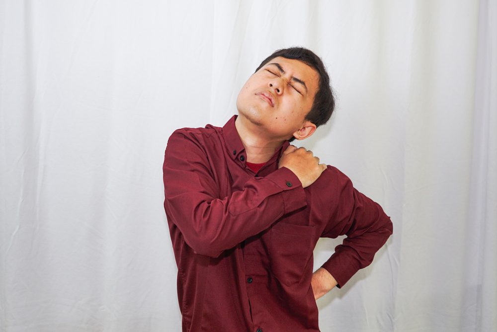 Trapped nerve in back. Man with back pain because of a trapped nerve.