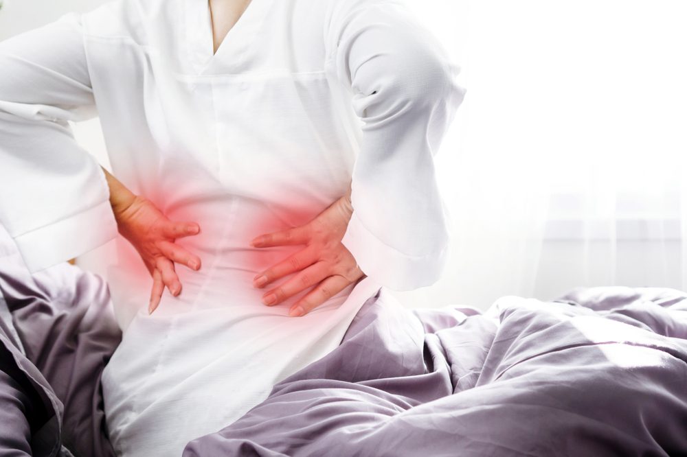 Elderly woman dealing with lower back pain