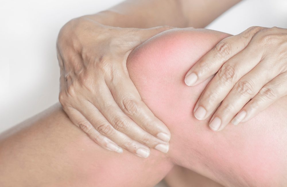 Physical therapy to help with knee swelling Person getting physical therapy to help with their knee swelling