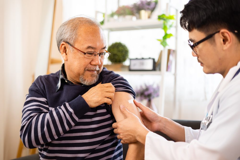 Doctor helping old man with an itchy arm without a rash