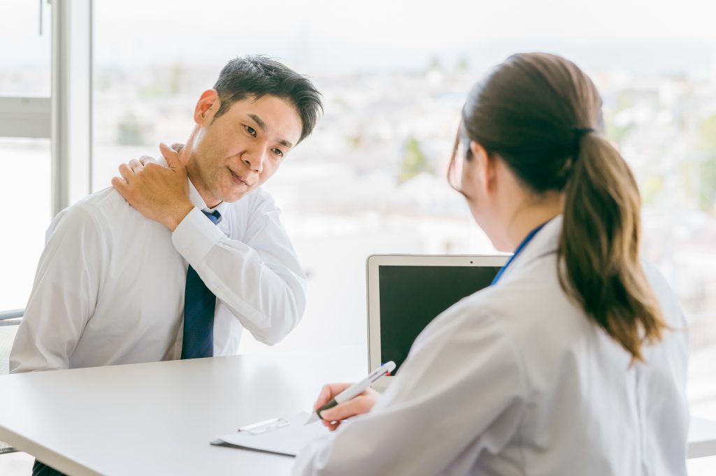 Physical therapist consulting patient with Calcific Tendonitis