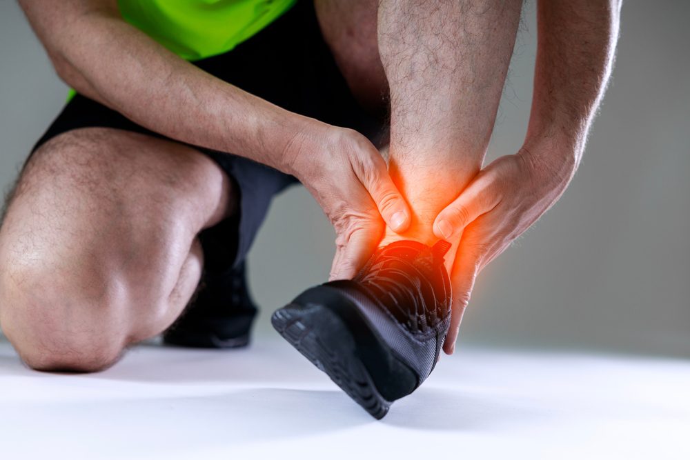 Man suffering from Ankle Pain while Running.