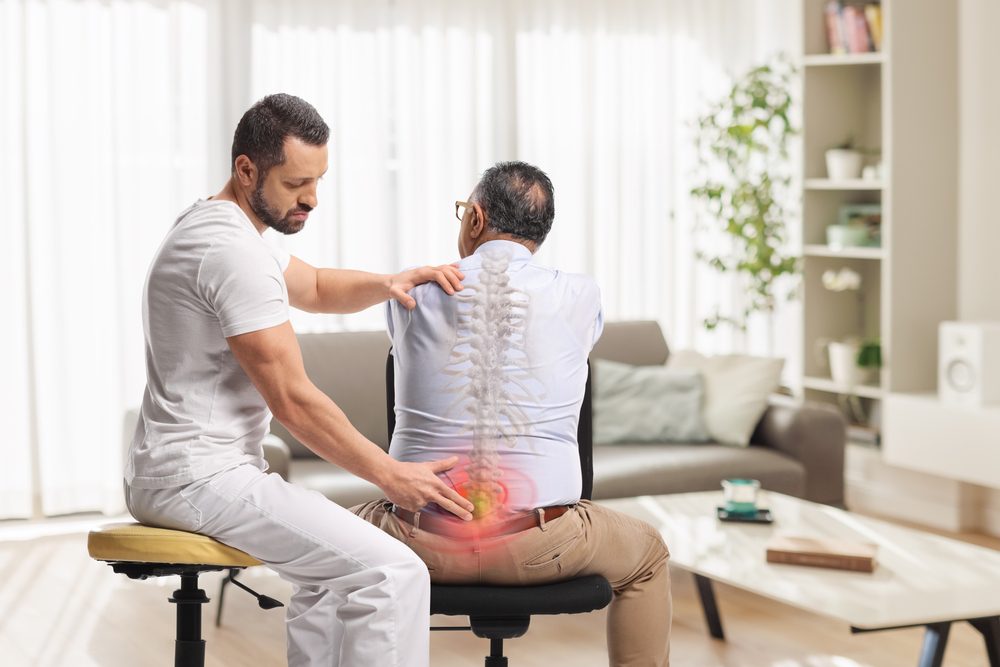 lower back pain treatment physical therapist helping someone with lower back pain