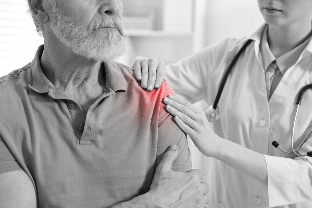 Shoulder Arthritis treatment. Physical therapist helping treat Shoulder Arthritis.