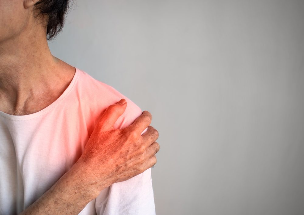 Shoulder Bursitis pain. Elderly woman in pain because of Shoulder Bursitis.