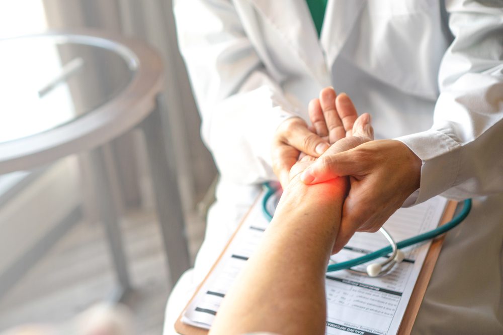 Muscle Strain treatment Doctor helping patient with Muscle Strain.