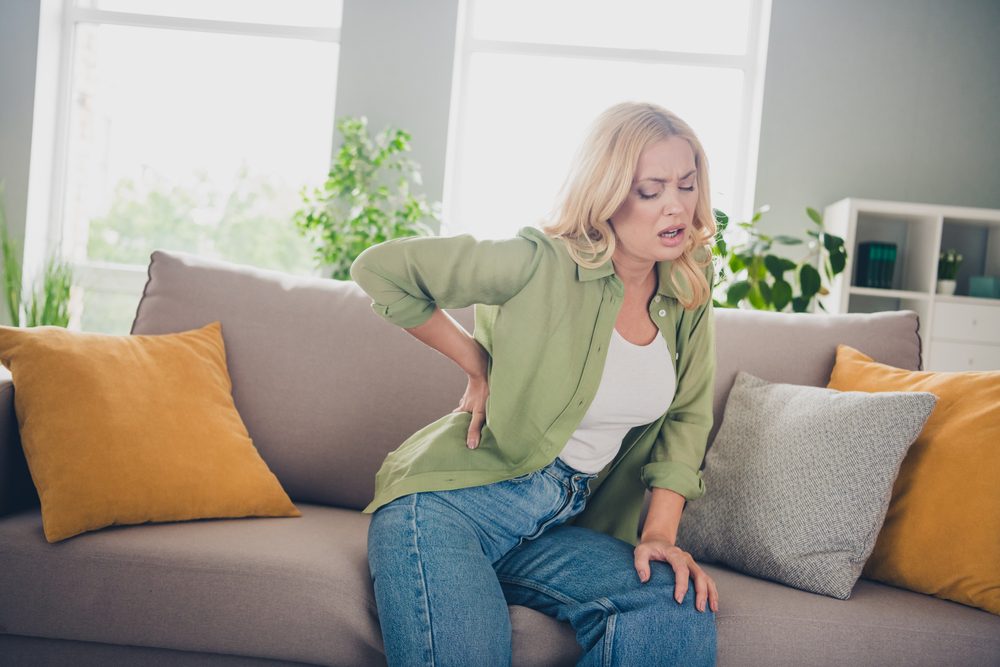 woman experiencing back pain due to Lumbosacral Spondylosis